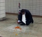 bissell Un homme mange par terre dans une station de métro